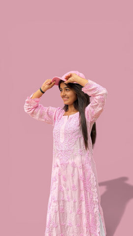 New India Fashion pastel pink Chikankari kurta with floral embroidery worn by a woman in a matching pink cap