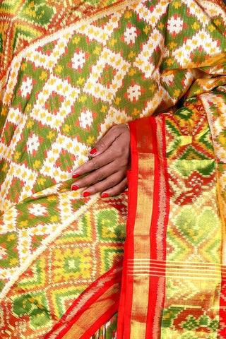 Red Pallu off white with green Patola Saree